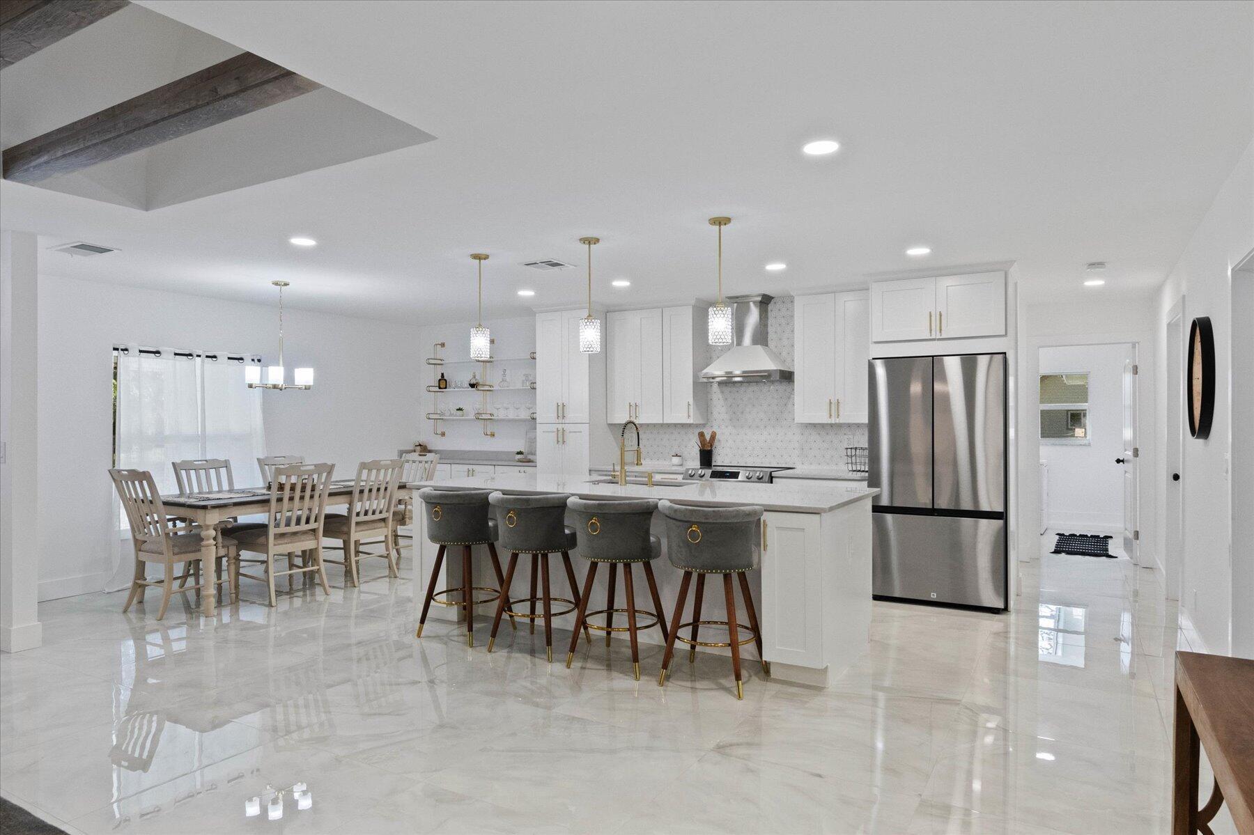 Discover your dream home in prestigious Pennock Point on a private 1/2 acre+ lot! This gem has a modern, open-concept layout, a stunning kitchen with a large island, quartzite countertops and stainless-steel appliances, seamlessly connecting to the dining and living areas adorned with large porcelain tile floors. The covered, screened-in patio features a beautiful tongue & groove ceiling, newly refinished pool! The master is a sanctuary with a spa-like bathroom & a deluxe dressing room style closet. The split floor plan is perfect for families or entertaining empty-nesters with the 3 additional bedrooms and a gorgeous bathroom in their own private space. A pantry/laundry room lead to the side-entry garage. Massive paver driveway. New Impact Windows and Doors. No HOA! Rare Find