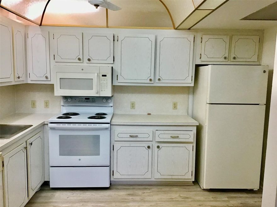 Light, bright, and spacious rarely available Model-C 1 bedroom, 1 bathroom 3rd floor unit with over 800 living square feet and central air conditioning in beautiful Preston at Century Village. This unit has been freshly painted, has newer carpet, a 2022 electrical panel, 2021 a/c and a brand new hot water heater. Kitchen and bathroom needs updating, but unit is clean and shows well. Master bedroom has a huge walk-in closet. Very large and open living area with two sets of sliders to the patio (great floor plan that rarely comes available). Large screened in patio and a lake view from the front of the building. Don't miss out on the opportunity to make this condo your own. 55+ dated adult community with great amenities including Clubhouse, Fitness Center, Pools, Tennis and more.