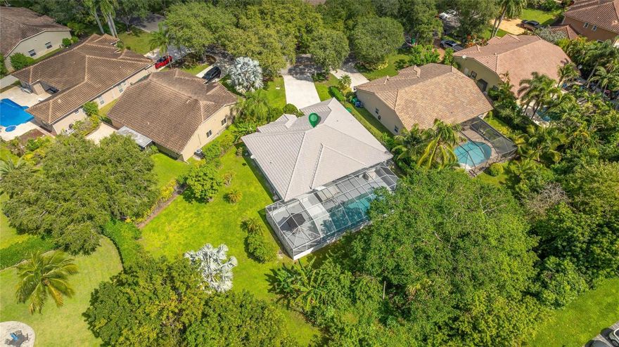 STOP THE CAR! This Maplewood home features a 45-foot screened-in, heated salt chlorinated pool located on a ½-acre private lot! Inside, the soaring vaulted ceilings throughout the living area fill the home w/ natural light. The spacious triple split floor plan offers a large family room, formal dining, living room & breakfast area. One of the secondary bedrooms has an en-suite bathroom that doubles as a cabana bath. Other highlights include epoxy floors throughout the main living areas & primary suite, laminate flooring in the other bedrooms, plantation shutters & an extra-long driveway. Enjoy accordion hurricane shutters, large patio & a backyard perfect for friends & pets w/ banana, papaya & mango! No HOA! Don’t miss this rare opportunity to call this Coral Springs home your own!