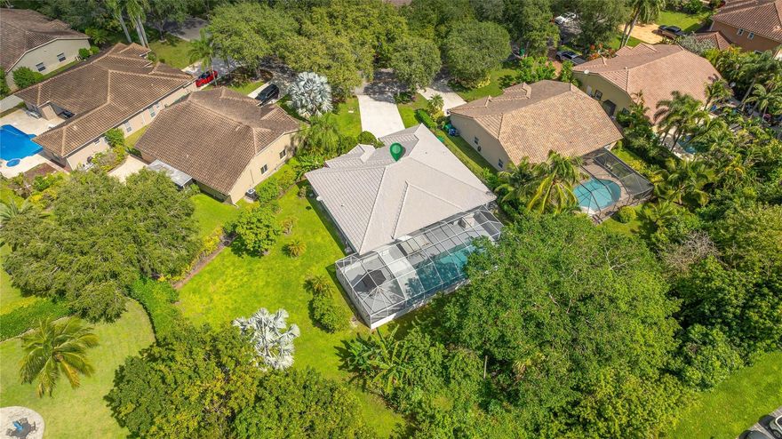 STOP THE CAR! This Maplewood home features a 45-foot screened-in, heated salt chlorinated pool located on a ½-acre private lot! Inside, the soaring vaulted ceilings throughout the living area fill the home w/ natural light. The spacious triple split floor plan offers a large family room, formal dining, living room & breakfast area. One of the secondary bedrooms has an en-suite bathroom that doubles as a cabana bath. Other highlights include epoxy floors throughout the main living areas & primary suite, laminate flooring in the other bedrooms, plantation shutters & an extra-long driveway. Enjoy accordion hurricane shutters, large patio & a backyard perfect for friends & pets w/ banana, papaya & mango! No HOA! Don’t miss this rare opportunity to call this Coral Springs home your own!