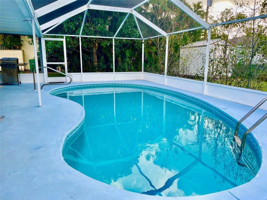 The total Square Feet: 2,618, including livable and non-livable areas such as lanai, porch, and garage. Lot size: 10,000 sq ft. This beautiful POOL home features 3 Beds/2 full Baths/2-car attached garage with an open split-bedroom floor plan and walk-in closets. No HOA or restrictions! The interior is updated with vinyl plank flooring (2021), a newer A/C (2020), water heater (2022), and electric panel (2021). It also boasts a new METAL ROOF (2021), washer/dryer (2021), and pool filter/heater (2021). Step outside to a fully screened-in pool area and a fenced backyard with lush landscaping for privacy—ideal for pets, play, or unwinding. Plus, enjoy your own mango tree! **This property was previously an Airbnb so it's great for investors for an extra income**