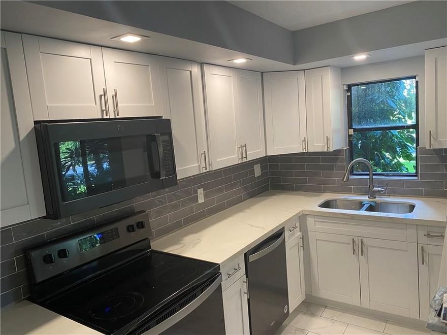 Great opportunity to buy a remodeled 1st floor condo in the heart of the city at an affordable price.  Central to downtown, beaches, parks, grocery stores of all kinds, and in a park like setting nestled away from all the hustle.  Jacuzzi style tub in guest bath! New kitchen cabinets and counters, new bathrooms, new flooring, paint, baseboards. Great ameneties including large community pool.  Monthly fee includes insurance, water, basic cable/internet, pool, dogpark, bbq area, car wash station, and pest control.