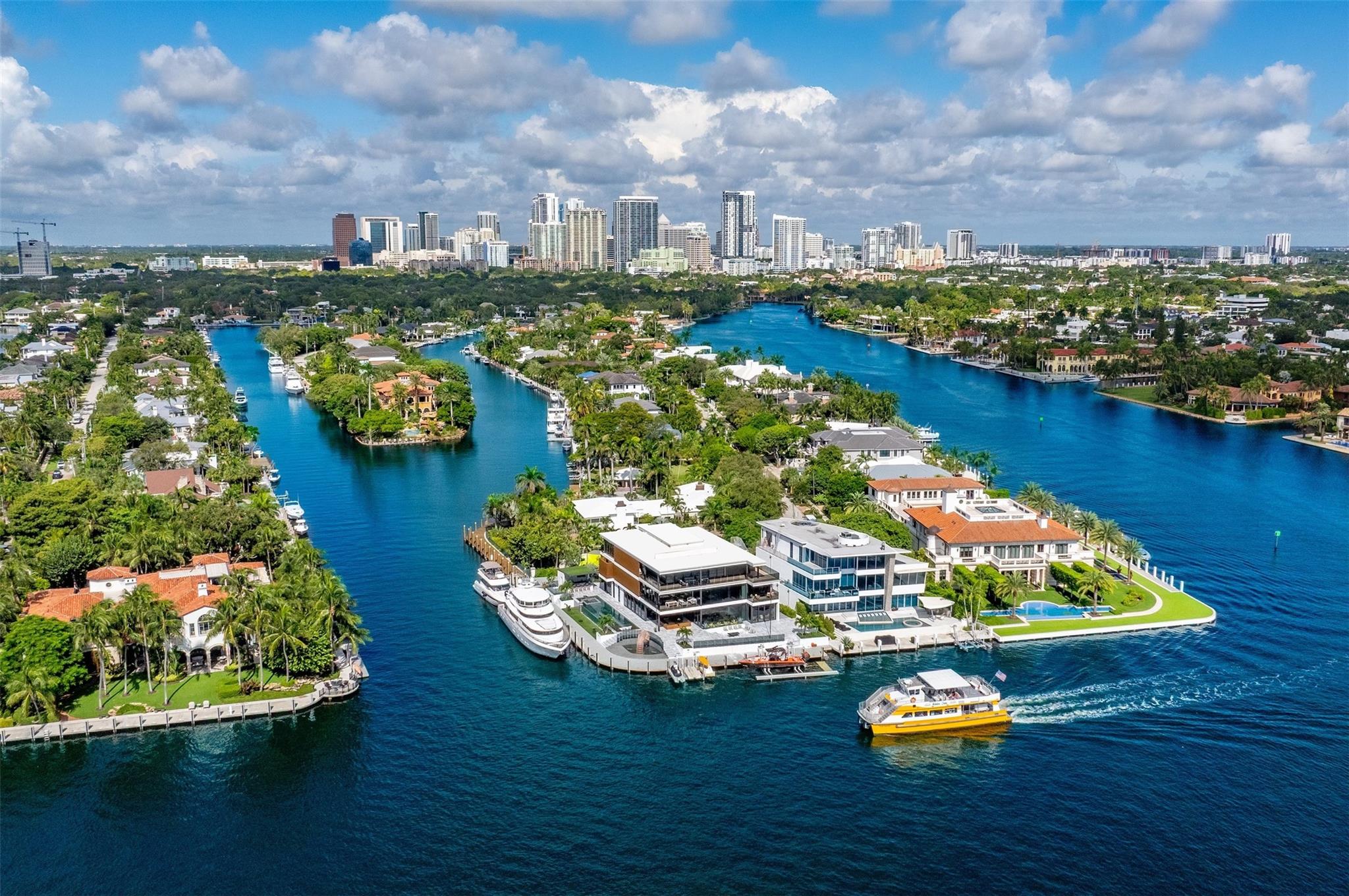 Enjoy the pinnacle of luxury living at this spectacular waterfront Point Lot estate in exclusive Rio Vista. A modern 3-story masterpiece, this residence showcases sophisticated interiors & private terraces capturing sunrise & sunset over the wide Intracoastal. W/7 bedrooms, a gourmet chef’s kitchen, soaring dbl-height livingroom, office, clubroom, & an indulgent indoor/outdoor primary bath, the home offers the perfect balance of comfort & grandeur. The third-floor sky lounge, gym, & guest suite create a true retreat, while expansive glass walls frame awe-inspiring views. For yachting enthusiasts, 250 feet of deep-water frontage accommodates even the largest vessels. Outdoors, enjoy a custom glass-facade pool, summer kitchen, and water features, all designed for unforgettable entertaining.