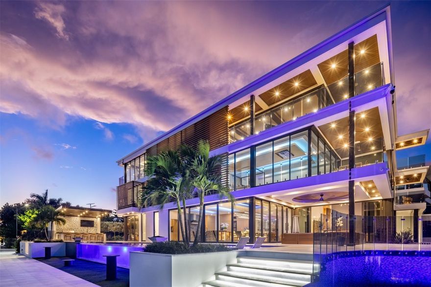 Enjoy the pinnacle of luxury living at this spectacular waterfront Point Lot estate in exclusive Rio Vista. A modern 3-story masterpiece, this residence showcases sophisticated interiors & private terraces capturing sunrise & sunset over the wide Intracoastal. W/7 bedrooms, a gourmet chef’s kitchen, soaring dbl-height livingroom, office, clubroom, & an indulgent indoor/outdoor primary bath, the home offers the perfect balance of comfort & grandeur. The third-floor sky lounge, gym, & guest suite create a true retreat, while expansive glass walls frame awe-inspiring views. For yachting enthusiasts, 250 feet of deep-water frontage accommodates even the largest vessels. Outdoors, enjoy a custom glass-facade pool, summer kitchen, and water features, all designed for unforgettable entertaining.