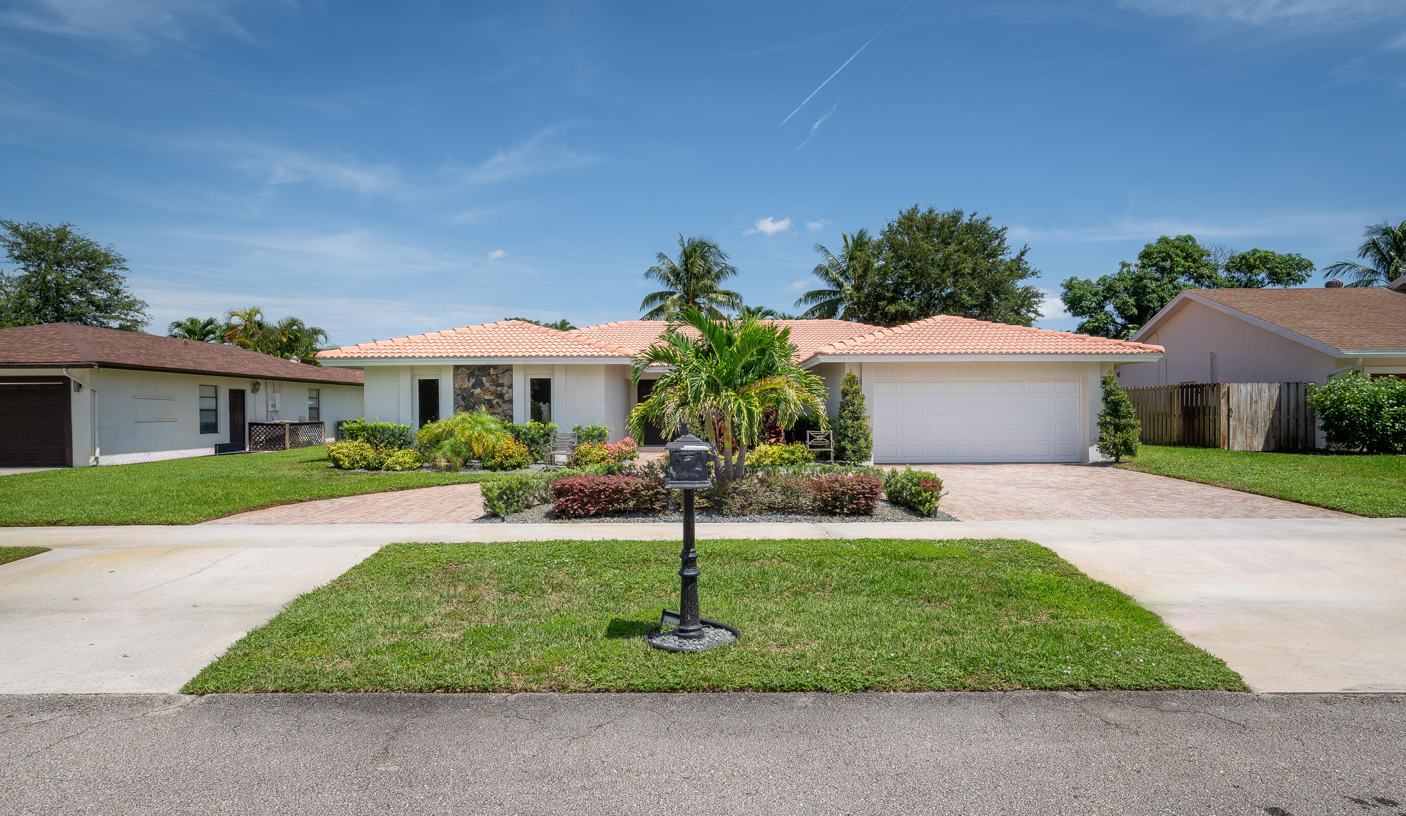 Welcome to your dream home in the highly sought-after Pheasant Walk community of Boca Raton. This beautifully renovated single-family residence offers 4 spacious bedrooms, 2 bathrooms, a 2-car garage, and over 2,220 sq ft of living space under air, designed for modern comfort and style. Step inside to an open-concept layout with smooth ceilings, recessed lighting, and abundant natural light. The chef's kitchen is the centerpiece of the home, featuring custom soft-close cabinetry with interior lighting, extra storage, a large island with stunning quartz countertops, and high-end stainless-steel appliances. Adjacent is a stylish bar with a dual-zone wine cooler and beverage center--perfect for entertaining. The living area showcases a custom-built entertainment center with an 85'' Samsung