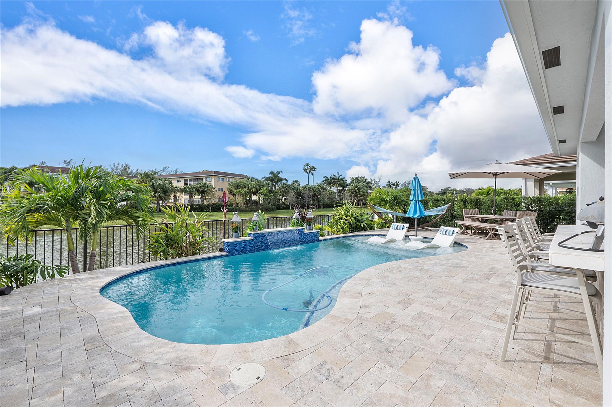 Your South FL tropical paradise awaits you in the gated, all ages resort-style community of Veleiros at Crystal Lake. This elegant & turnkey 2BR + Den / 2bath /2car home comes completely furnished with Key West decor and custom finishes abound like plank tile flooring, multiple wall accents, Quartz counter tops, & trendy cabinetry, hi-hat lighting, SS appliance set, and High-impact windows & doors. Enjoy the full outdoor kitchen/BBQ patio overlooking a freshwater canal, while you frolic in the heated or cooled private pool with surround sound & large screen TV. Paver brick driveway is extended for ample guest parking. Deerfield Beach is just 10-15 minutes away, and plenty of shopping and schools are nearby. Clubhouse & Community pool /workout facility just a short walk away. LOW HOA!