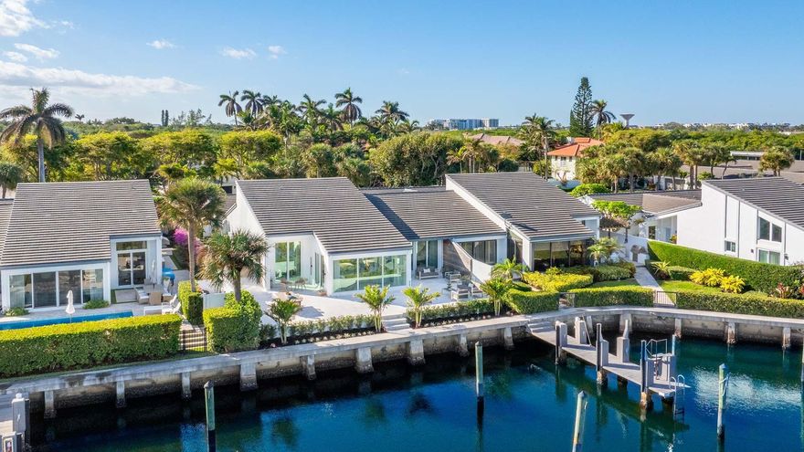 Meticulously updated, this Ocean Ridge townhouse villa is located in the gated waterfront community of Pelican Cove with nearby beach access. The residence exudes a tranquil feel throughout with natural light and exceptional finishes including wood vaulted ceilings; custom cabinetry and countertops; top-of-the-line appliances and fixtures; custom stone and wood accents; custom lighting and more. The interior living areas flow effortlessly with water views and easy access to outdoor living via sliders. Features include dining and living area with wine refrigerator, wet bar and gas fireplace; open kitchen with island and pantry; powder room off entryway; primary suite with stunning bathroom, walk-in closet, and access to the waterfront terrace; en suite guest room; office with Murphy bed;