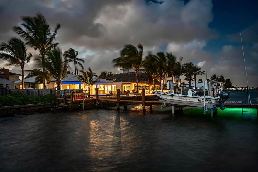 Fully Furnished Just bring your toothbrush. Direct Intracoastal pool home. Boater's delight - to the inlet from your dock in 3 minutes! Boat Dock and jetski lift. Immaculate, well cared for home with picturesque wide Intracoastal views. Located in the boater's haven community of Harbor Estates. Don't wait to see this home. Sleeps 8. Accessible platform LIFT for water sports and BYO jetskis. Available kayaks and paddle boards for use. Lounge on the hammock over the sand or sit in the suspended chair beneath the Tiki Hut. Gourmet outdoor grill and burners. There is an insta-hot Two tikis out door Kitchen Tiki & Dock Tiki, Green egg for smoking, grilling, or homemade pizza. Watch, feed or catch many species of fish off the 160 feet dock