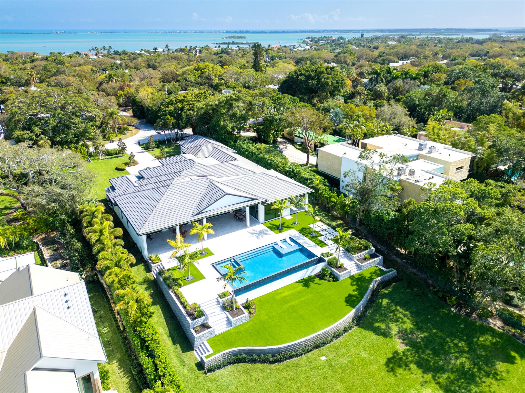 Introducing ''Villa Acquabella'', The Pinnacle of Waterfront Luxury. Situated on almost 1 and a quarter acre, this estate features 127 feet of deep water frontage and is 36 feet ABOVE Sea Level!Be the first to own the newest and first new construction waterfront home in the exclusive Sewall's Point, Barrier Island. Designed by the esteemed Arthur Rutenberg Homes, this architectural masterpiece offers 5,391 square feet under air and an expansive 8,479 total square feet, seamlessly blending coastal elegance with modern sophistication.A Home Designed for Luxury & Entertaining! Floor-to-ceiling windows frame breathtaking water views, while soaring ceilings, custom millwork, and designer finishes elevate the home's grandeur. Whether hosting intimate gatherings or lavish soirees,
