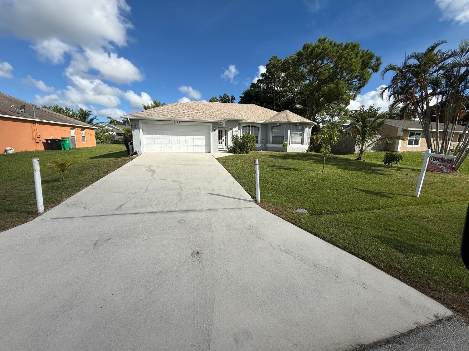 Located in central Port St Lucie, this 3-bedroom, 2-bathroom home is ready and waiting for its next owner to add their personal touch and make it their own. With rising insurance costs, you'll be pleased to know that the roof was replaced in early 2023. The 120 gallon propane tank services the range, water heater, and dryer. Featuring a formal living, den, formal dining area, and eat-in kitchen, there's room for everyone to have their own space. The special details such as plant shelves with outlets, vaulted ceilings, niches for decor, and arched doorways make this home a great canvas for your updates and decor options. Formal living area and primary bedroom have been upgraded with beautiful wood-look plank tiles. Carpet and tile flooring in remaining areas.