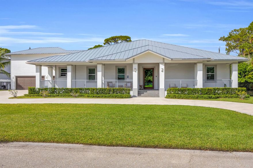 Experience the pinnacle of modern luxury at 5481 Hibiscus Rd, a 2022-built custom CBS estate with a detached guest cottage, perfectly situated in the prestigious Pennock Point neighborhood of Jupiter. Every detail of this residence reflects thoughtful design and timeless sophistication.Step inside to soaring 12-foot ceilings, elegant crown molding, and plantation shutters throughout. The heart of the home is a chef-inspired kitchen featuring solid wood cabinetry, soft-close drawers, and dual oversized islands. Exquisite marble and quartz countertops complement a suite of premium GE Monogram appliances, including a 6-burner gas range with griddle, pot filler, built-in ice maker, and wine cooler. The open-concept layout flows seamlessly into the dining and living