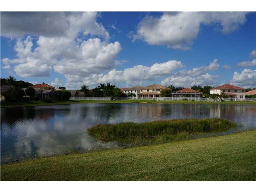 Beautiful Lake and Pool home in the highly sought after Weston Community of The Ridges! Popular Edison model offering 5 bedrooms with 4 full baths. 1 bedroom and full bath downstairs. Spectacular Lake Views throughout!! Updated Kitchen with granite counte r tops, stainless steel appliances, 2 new AC units, freshly painted exterior. Tile floors in al living areas and Berber carpet in all bedrooms. Renovated guest bath. Walking distance to all schools and library.