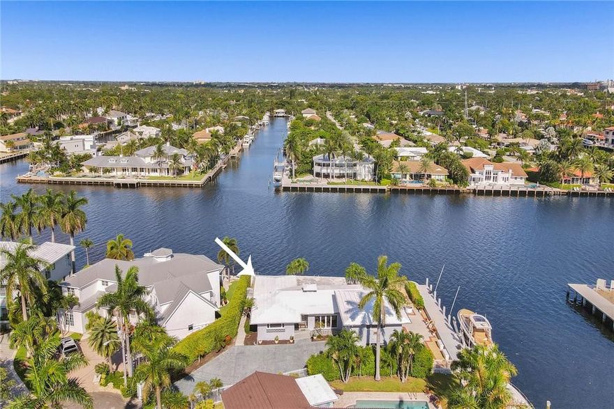 This amazing point lot has over 200 feet of waterfront with 100+ on the intracoastal. Brand new seawall upgraded to existing standards surrounds the property and includes a 27,000 pound boatlift. Existing Three bedroom, 4 bath home is lovely with a mid century design and gorgeous Ketchum/Cuban tile floors, recently updated with fresh paint and modern lighting. Completely renovated guest suite includes one bedroom /one bath above the garage, two bedrooms and two baths in the existing house. Ready for your custom designed home or live in the existing charming home. Amazing views, amazing potential!