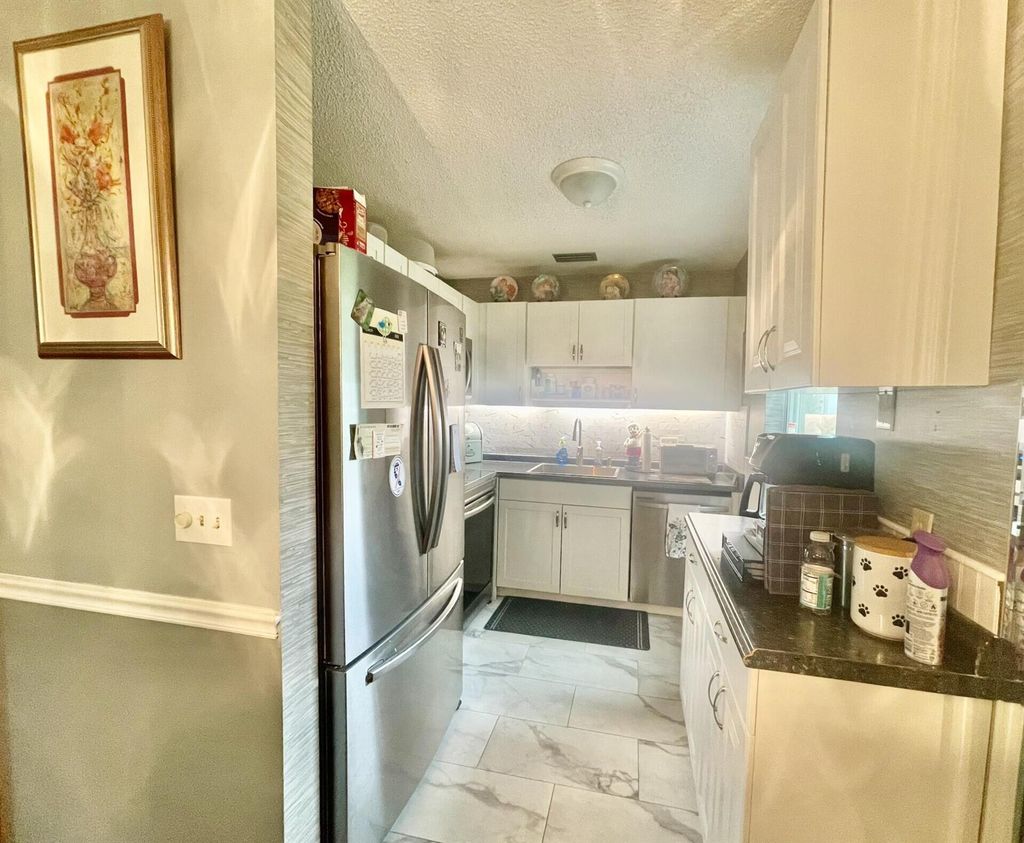 Photo of 29 Lake Vista Trl #105, Port Saint Lucie, FL 34952 (MLS # R11071863)