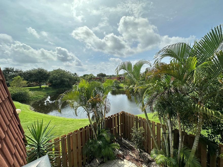 Picture yourself in this charming two-story townhouse, overlooking the lake, in fabulous Delray Beach. Close to shopping, minutes from the highway and a short drive to the lively downtown area and pristine beach! Tastefully updated 2 bedrm/ 2 & 1 1/2 bath with a newly renovated kitchen, and new laminate floors throughout the home. Spacious closets, and balconies in each bedroom suite, which allow you to wake up to the water view and expansive sky, while overlooking your private, fenced-in patio and garden making you feel as if you're living in paradise! Full size washer & dryer. Bright and light townhome. Community amenities include a lovely pool and tennis court. 2 assigned parking spaces, Beautifully manicured parklike grounds throughout the neighborhood.  Move in 12/1/2025 with HOA appr