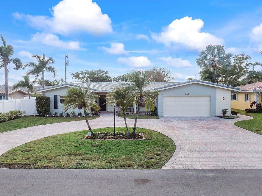 Welcome to this turnkey Coral Ridge Isles Oasis. This remodeled 4-bed, 2-bath pool home with a 2024 NEW ROOF features new luxury vinyl flooring throughout, recessed lighting, new paint and a skylight. The remodeled kitchen (2023) features sleek white shaker cabinets, quartz countertops, and a spacious walk-in pantry. Lots of storage with extra closets and an expansive two-car garage with an automatic hurricane-proof door. Stay comfortable year-round with dual air conditioners (new in 2021 and 2023) and full hurricane protection. This home offers additional upgrades including an upgraded sprinkler system (2023), replaced attic insulation (2023), and pool resurfaced with gemstone and adorned with new tile, filter, and skimmer (2024). Your relaxation awaits in the sprawling backyard.