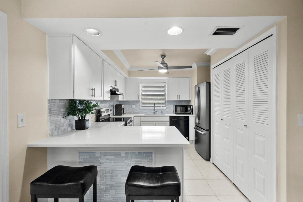 Photo of 4885 SE Capstan Avenue #E-27, Stuart, FL 34997 (MLS # R10873472)