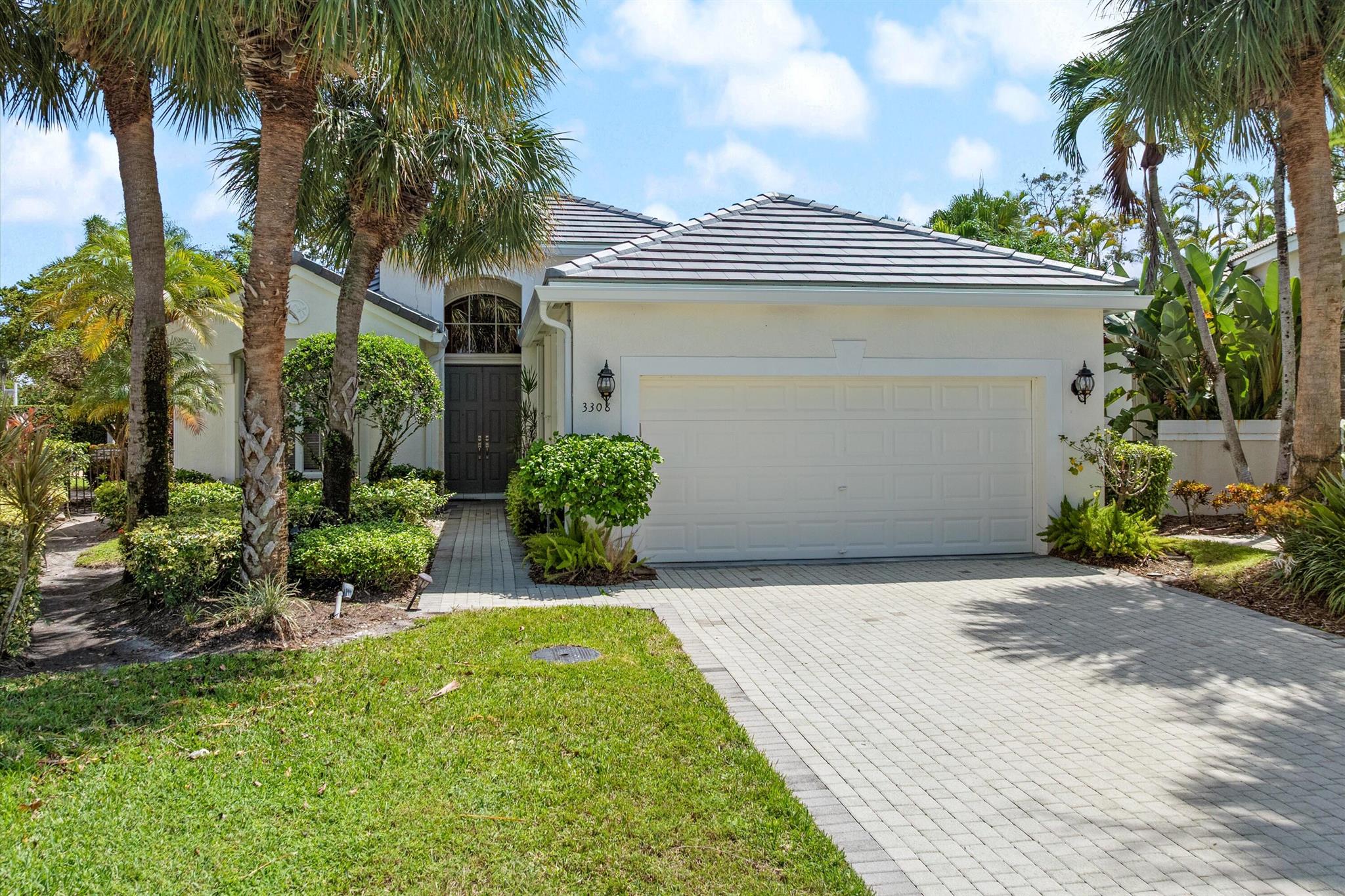 Welcome to Stratford Green, an exclusive enclave within the prestigious Woodfield Country Club in Boca Raton. This beautifully maintained single-family home offers 3 bedrooms and 3 full bathrooms on a spacious lot, presenting an excellent opportunity to customize and refresh to your personal taste. Originally built in 1995, the home features a brand-new flat tile roof completed in August 2025, along with a whole house generator powered by natural gas providing peace of mind for years to come.Inside, the thoughtfully designed 3-way split floor plan ensures privacy for each bedroom. The main living areas are characterized by soaring volume ceilings and large windows that fill the space with natural light. While the home is in solid condition, it would benefit from minor cosmetic