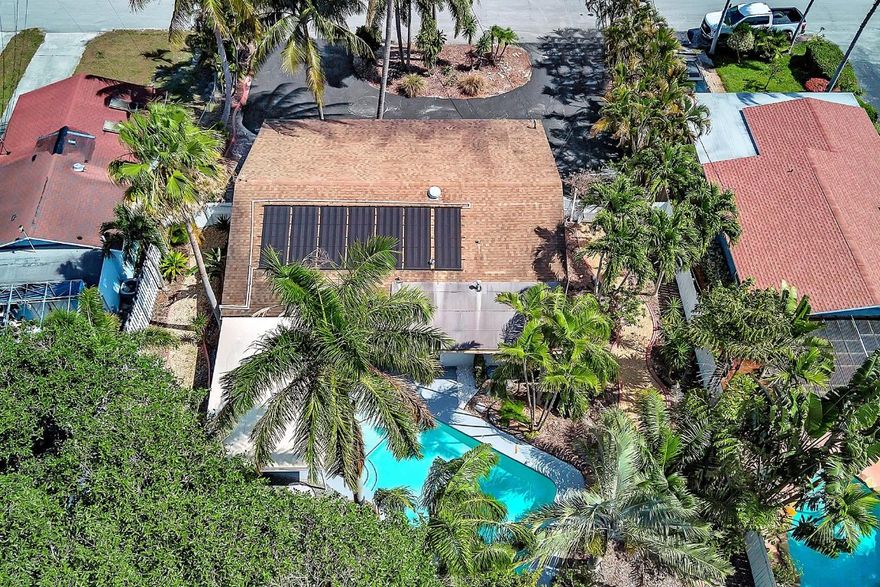 Welcome to tropical living in this beautifully updated East Fort Lauderdale home on an expansive 10,000+ sq. ft. double lot. The open layout features hurricane-impact windows and doors, recessed lighting, and stylish tile flooring throughout. The kitchen is enhanced with quartz countertops, stainless appliances, and custom cabinetry. Two flexible rooms offer options for a fourth bedroom, office, or guest suite. Step outside to a private fenced yard with vibrant landscaping, a solar-heated pool, and a covered patio perfect for relaxing or entertaining. Offered fully furnished and move-in ready—ideal for living, vacationing, or investment.