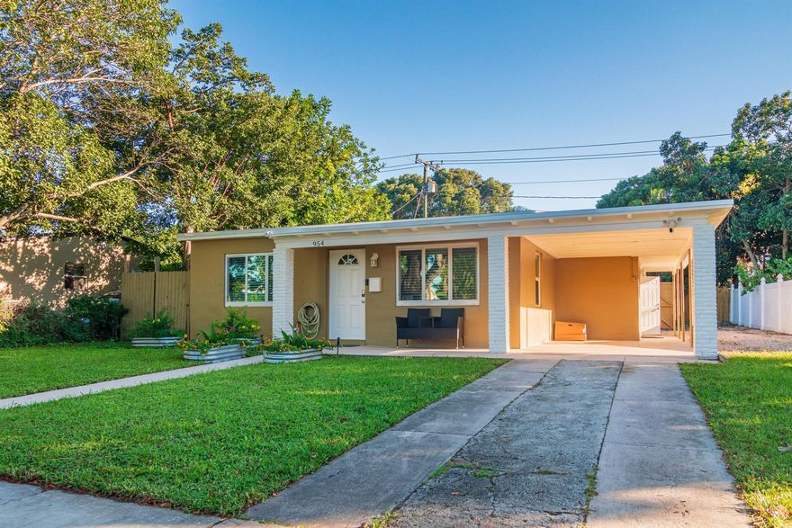 Stylishly Remodeled Gem in West Palm Beach!This beautifully upgraded 3-bedroom, 1-bath home perfectly combines modern finishes with warm Florida charm. From the moment you arrive, you're greeted by a lush front yard, mature shade trees, and a welcoming covered patio--ideal for relaxing in the evening breeze. Step inside to find an open-concept living area with exposed wood beams, crown molding, recessed lighting, and luxury wood-look tile flooring throughout.The custom kitchen is a showstopper with glossy European cabinetry, quartz countertops, a farmhouse sink, stainless-steel appliances, and a stunning glass mosaic backsplash. Enjoy meals in the cozy dining nook featuring a handcrafted wood table and built-in bench under a rustic chandelier.
