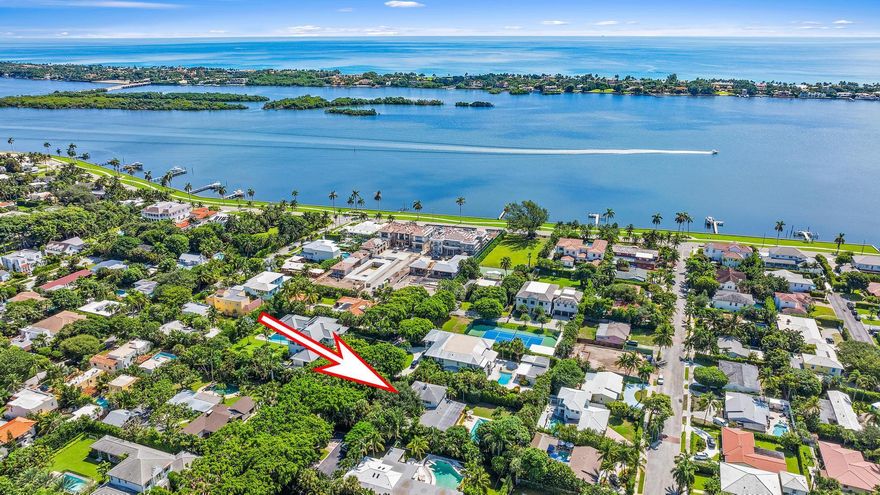 Welcome to 232 Essex Lane! Rare chance to secure a 19,009 sq. ft. lot on one of SoSo's most prestigious streets. Complete with a canopy of banyan trees lining the cul-de-sac, this property offers endless options for those looking to expand or create a custom estate. The current home, a perfect blend of classic Florida elegance & modern updates, includes 4,295 total sq. ft, 4 bedrooms, 5 bathrooms, an office nook & a garage. Unwind in the expansive loggia, offering peaceful views of the lush backyard & swimming pool. The kitchen, featuring quartz countertops & a built-in breakfast nook, effortlessly connects to the outdoor living areas. With a seamless indoor-outdoor flow, this space is perfect for quiet moments or hosting larger gatherings.