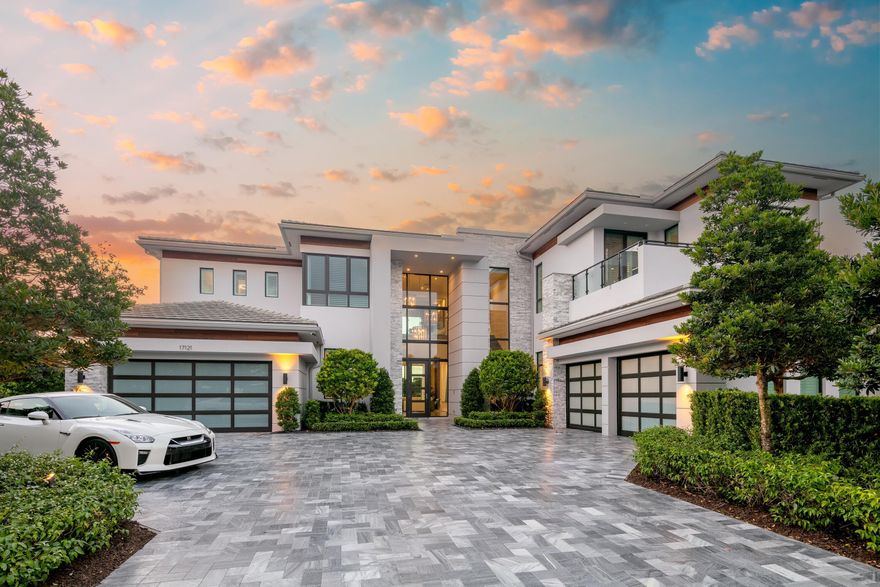 The grandeur of resort style living finds the perfect residential complement inside one of Boca Raton's most celebrated luxury communities. Amid the amenity rich backdrop of Boca Bridges, the prestigious gated development of multimillion dollar estates from GL Homes, 17121 Brulee Breeze Way stands alone, a sprawling lakefront masterpiece brimming with clean lined sophistication. This coveted Vanderbilt Grand Contemporary model, the largest offering at Boca Bridges, encompasses nearly 11,000 sf of overall living space (8,092 sf under air). This exquisite estate features the highest level of finishes, privacy and timeless design by Susan LaChance Interiors. Cast with verdant landscaping on a cul de sac lot that covers more than a half acre, the two story layout inspires at every turn.