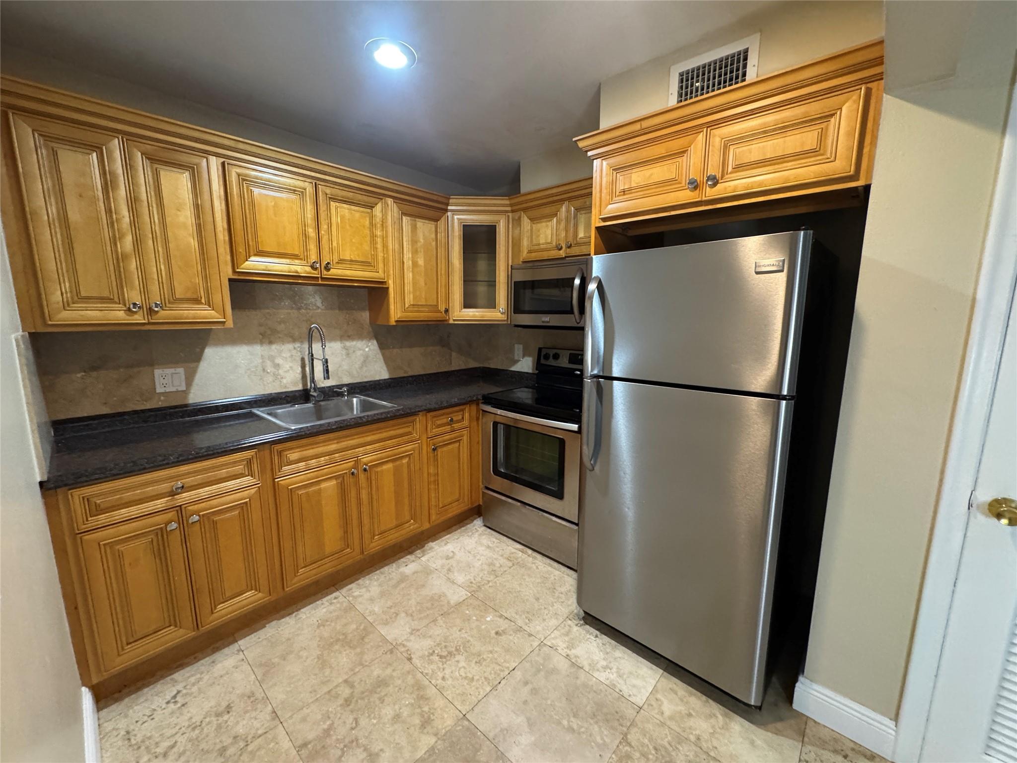 This is a Newly REMODELED 1st floor STUDIO apartment in the heart of Davie, and perfect for a student to excel in their studies! Enjoy the New Stainless Steel appliances, new wood & tile flooring, two tone paint w/ new baseboards, upgraded kitchen faucet, tile walk in shower, dedicated parking spot outside your door, easy to bring in your groceries, and laundry facility on the same floor. This is the most ideal location to Nova Southeastern or Broward College, many grocery stores such as Trader Joe's, Publix, & Whole Foods, down the road to Costco, Wawa, downtown Davie & Fort Lauderdale, easy access to I-595 & I-95 for commuting, & the Hard Rock Casino. Owner is seeking a 1 year lease, & a non-smoking person. Schedule your showing today!