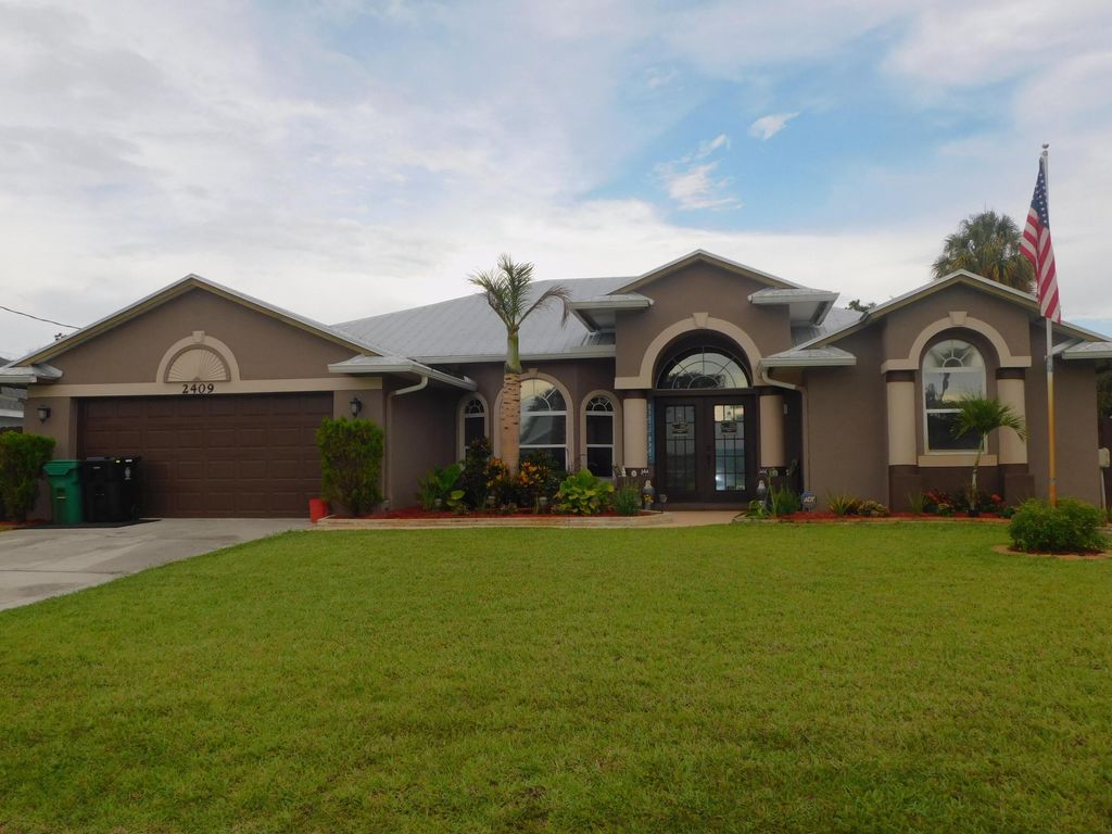 Photo of 2409 SW Washington Street, Port Saint Lucie, FL 34953 (MLS # B26034252)