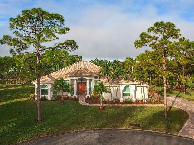WOW! Beautifully remodeled home on 1.38 acres in the sought after gated community of Bay Hill Estates. Features include a designer kitchen,42'' cabinets, under cabinet lighting, GE Profile SS appliances and seamless granite counters. Tropical heated pool with salt system. Crown molding throughout as well as several rooms with chair rail molding. High efficiency LED lighting throughout as well as stereo speakers including back porch. 2.5 car garage with epoxy painted floor and extensive cabinetry. Newer plank porcelain wood looking tile floors in foyer, office & DR.. Many tropical fruit bearing trees