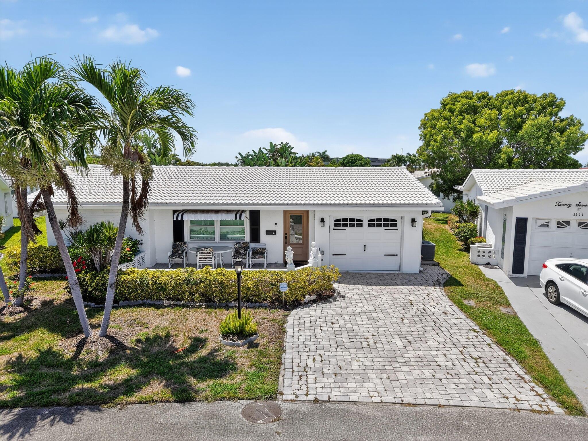 Welcome to 2019 Vastine Dr, located in a desirable 55+ community in the heart of Boynton Beach. This move-in ready home has been thoughtfully upgraded with plantation shutters, impact windows in the front, and double-pane windows throughout.The kitchen and appliances have been updated, and the interior features crown molding throughout and updated laminate flooring. Step outside to your open porch facing the golf course, offering peaceful views and the perfect spot to unwind. There's also a screened patio for additional outdoor enjoyment.Key upgrades include: New A/C units and ductwork (2022), New thermostat (2025), 1-car garage, Washer and dryer included.Enjoy comfort, style, and scenic views in a vibrant 55+ community close to shopping, dining, and medical services