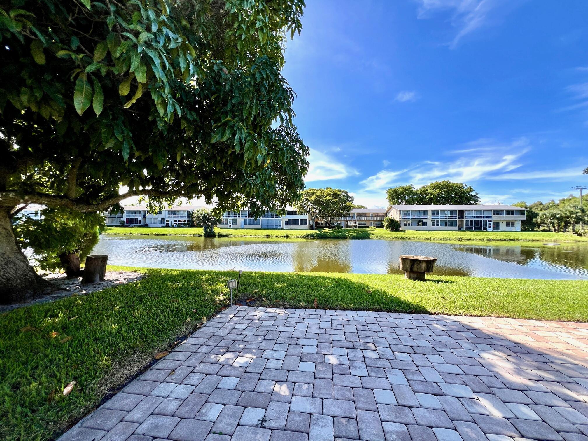 Enjoy Gorgeous Water Views in 55+ Century Village! Light & Bright FIRST FLOOR CORNER 2/1.5 With Private Water Side Patio Just Outside the Lanai! Updates to Kitchen & Baths. Neutral Tile Flooring Flows Throughout. Enclosed Lanai With Access to the Private Water Side Patio. Accordion Shutters All Around for Hurricane Protection. New electrical panel with permits. Nicely Maintained Building With Expansive Resident Water Side Patio. Great Location Close to Hastings Fitness Center! Century Village is a 55+ Resort Style community with so much to offer..