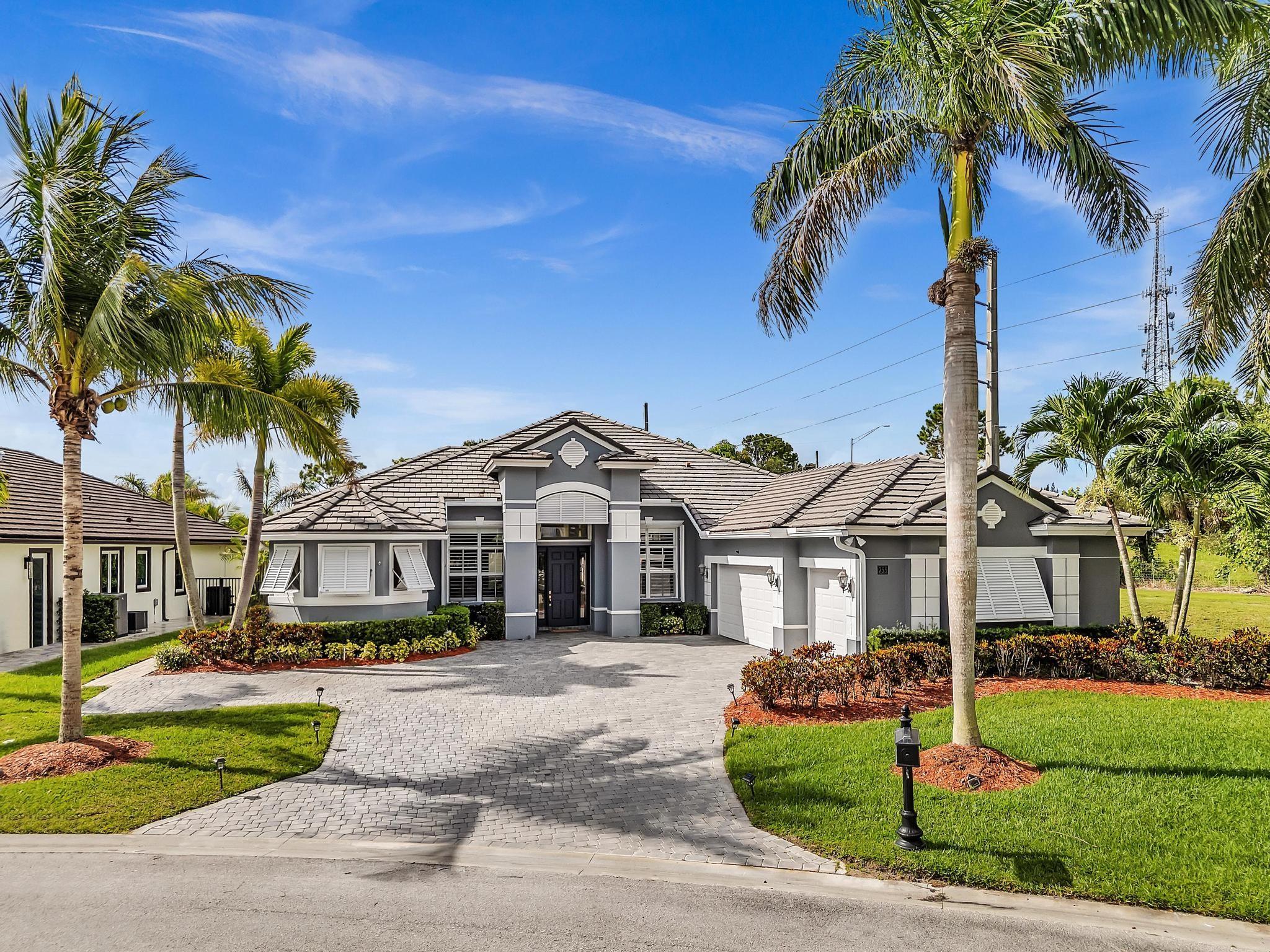Golfers and Boaters paradise!! Home sits on a corner lot, frontal lake view in prestigious subdivision. This expansive 4-bedrms +den, 3-baths home, 3-car garage, volume ceilings, separate living, family area, with chef's kitchen is equipped with center island, granite countertops, double oven and Formal dining-room. Experience the essence of Florida living with a private enclosed screened-in heated saltwater pool and spa, with outdoor cooking area, mature fruit trees. The master ensuite features an oversized dual shower and a soaking tub. Amenities include clubhouse, fitness center. Comes with its own private boat lift, and an extended dock on a deep-water canal with ocean access and no fixed bridges. Close proximity to The Florida Golf Club. Don't miss the chance to call this home yours!