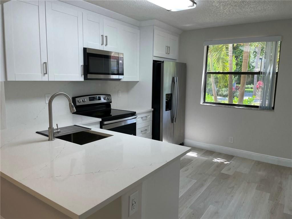 Photo of 5741 Riverside Dr #101A5, Coral Springs, FL 33067 (MLS # F10283102)