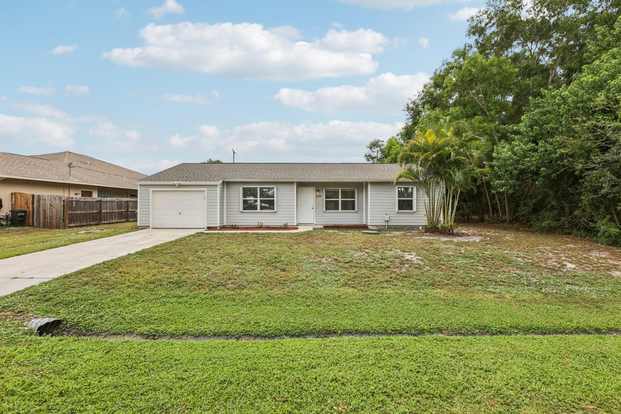Bright and inviting, this 3-bed, 2-bath Port St. Lucie home offers comfort and style. Tile and vinyl floors flow through a spacious, light-filled layout with abundant windows. The modern kitchen features a sleek cooktop/oven combo, microwave, and dishwasher. A 1-car garage adds convenience, while the large fenced backyard is perfect for pets, play, or gardening. Recent updates include a brand-new roof (1 month old), 6-year-old AC, and 2-year-old water heater. Located near shopping, dining, parks, and just 20 minutes to Hutchinson Island beaches, plus easy access to I-95 and the Turnpike. Move-in ready!
