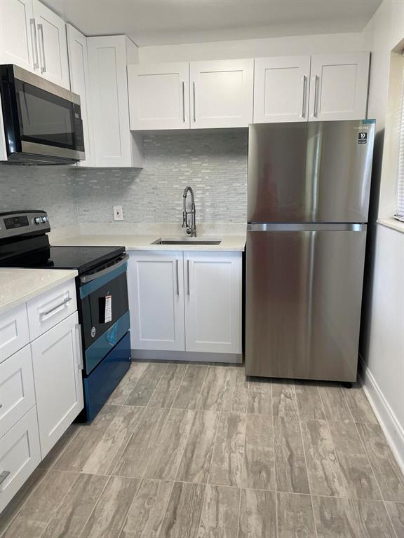 AVAILABLE INMEDIATELY! 1st-floor corner condo located on a quiet dead-end street. Lots of natural light in this renovated 2 bedroom, 1.1 bathrooms, with wood laminate and tile floors, walk-in shower, plenty of storage & a fully enclosed lanai & a back door leads outside to open green space. Century Village is a 55+ gated community with resort style recreational facilities. Inside the 92,000 sq ft clubhouse features a 1,221 seat theater that has regularly-scheduled shows & free movies, numerous meeting rooms for hosting card games, classes, clubs, billiards, bingo and so much more! The health club is equipped with the latest exercise equipment, yoga, aerobics & more. The amenities continue outside the clubhouse, 2 pools, tennis, bocce, shuffleboard, pickle-bal