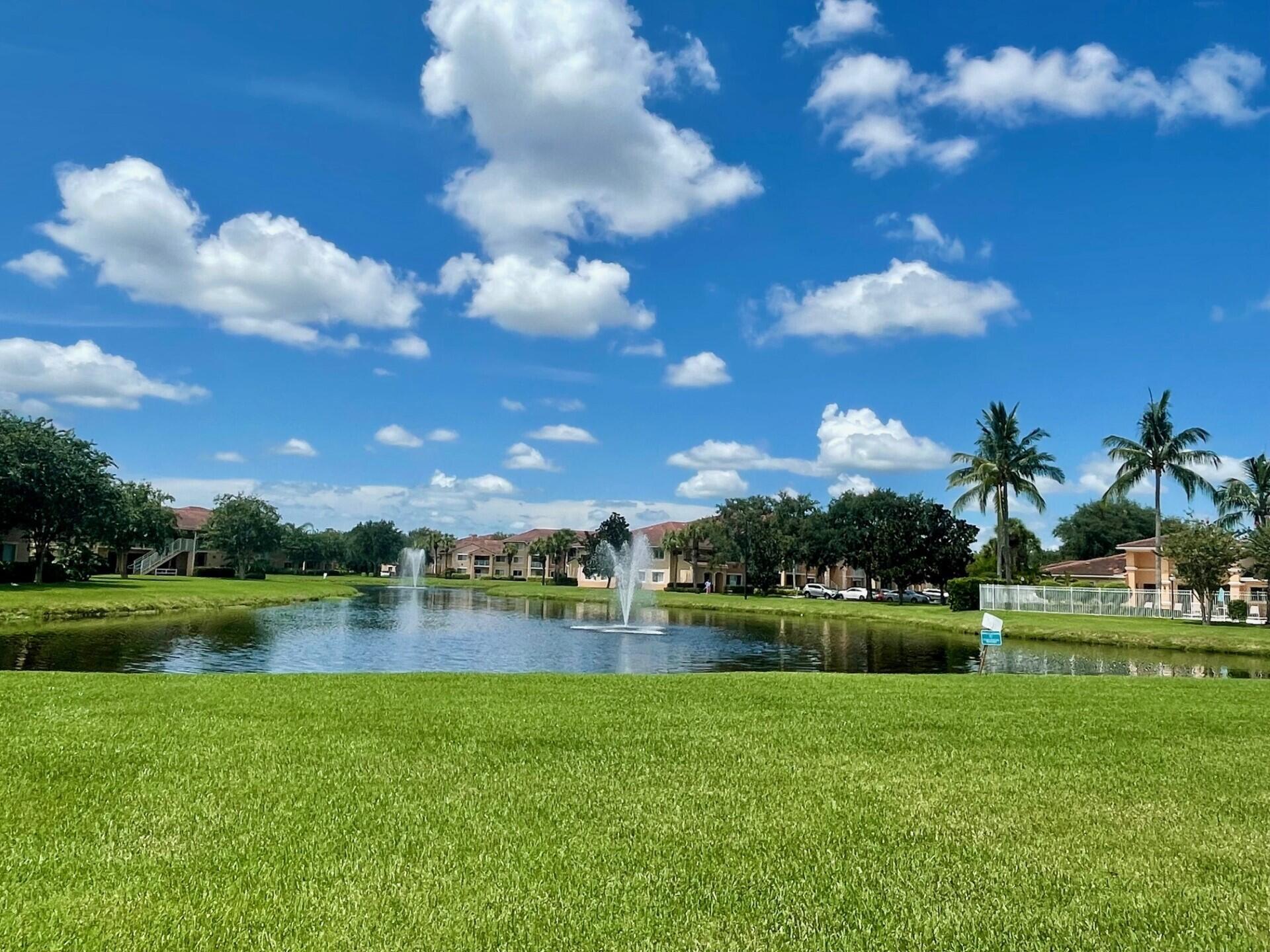 Great first floor location in The Club overlooking the lake and pool. Wood kitchen cabinets, granite counters, neutral tile throughout, wood and granite vanities, full size washer and dryer. Open patio with beautiful views. Extra storage closet. Gated complex offers beautiful community pool, fitness center, club house, playground and bbq area. Well maintained community just east of I-95.