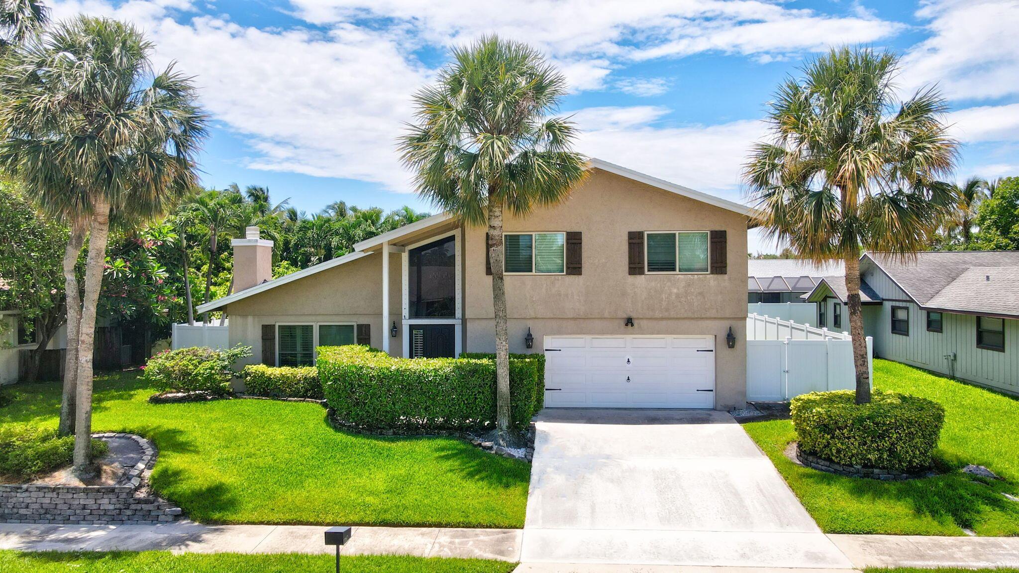 Discover this exceptional home in the highly sought-after East Boca's Pinelands North with no HOA. This charming residence features impact windows & doors, plantation shutters ,exquisite exposed wood beams, custom lighting & cozy fireplace The bright natural light kitchen boasts skylights, premium appliances that flows seamlessly into the spacious living perfect for entertaining. The living area opens through sliding glass doors to the private huge backyard outdoor oasis. Upstairs offers a large primary suite with a renovated bath, along with two guest rooms & an updated guest bathroom. Recent upgrades include a new upstairs HVAC (2025), a roof (2018). New deck, an outdoor staircase, & a new pool heater. The backyard has a new fenced large yard, outdoor kitchen, firepit, & lush fruit Tree