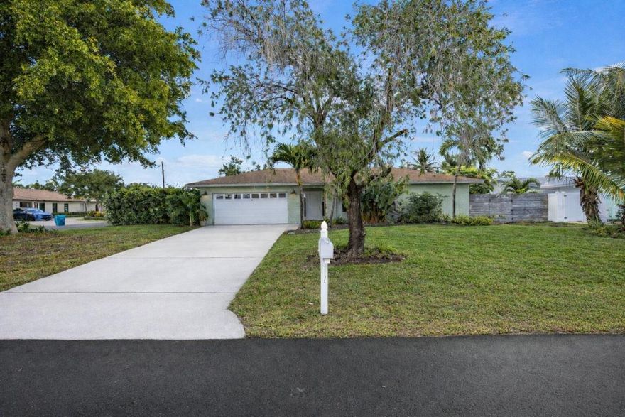 Beautifully remodeled 4-bedroom, 2-bathroom pool home with a 2-car garage, ideally located in the heart of the City of Boynton Beach. Situated in a desirable community with NO HOA, this bright and open residence sits on a large, fully fenced corner lot of approximately ¼ acre, featuring mature mango, avocado, and coconut palm trees. The home offers an open-concept layout with tile floors throughout, abundant natural light, impact windows and doors, and a modern kitchen complete with a center island, pantry, quartz countertops, and stainless steel appliances. The spacious backyard includes an open porch perfect for entertaining, a sparkling pool, and a convenient cabana bath. Ideally located just minutes from I-95, Palm Beach International Airport, beautiful beaches, and golf courses. Make this stunning home your today!