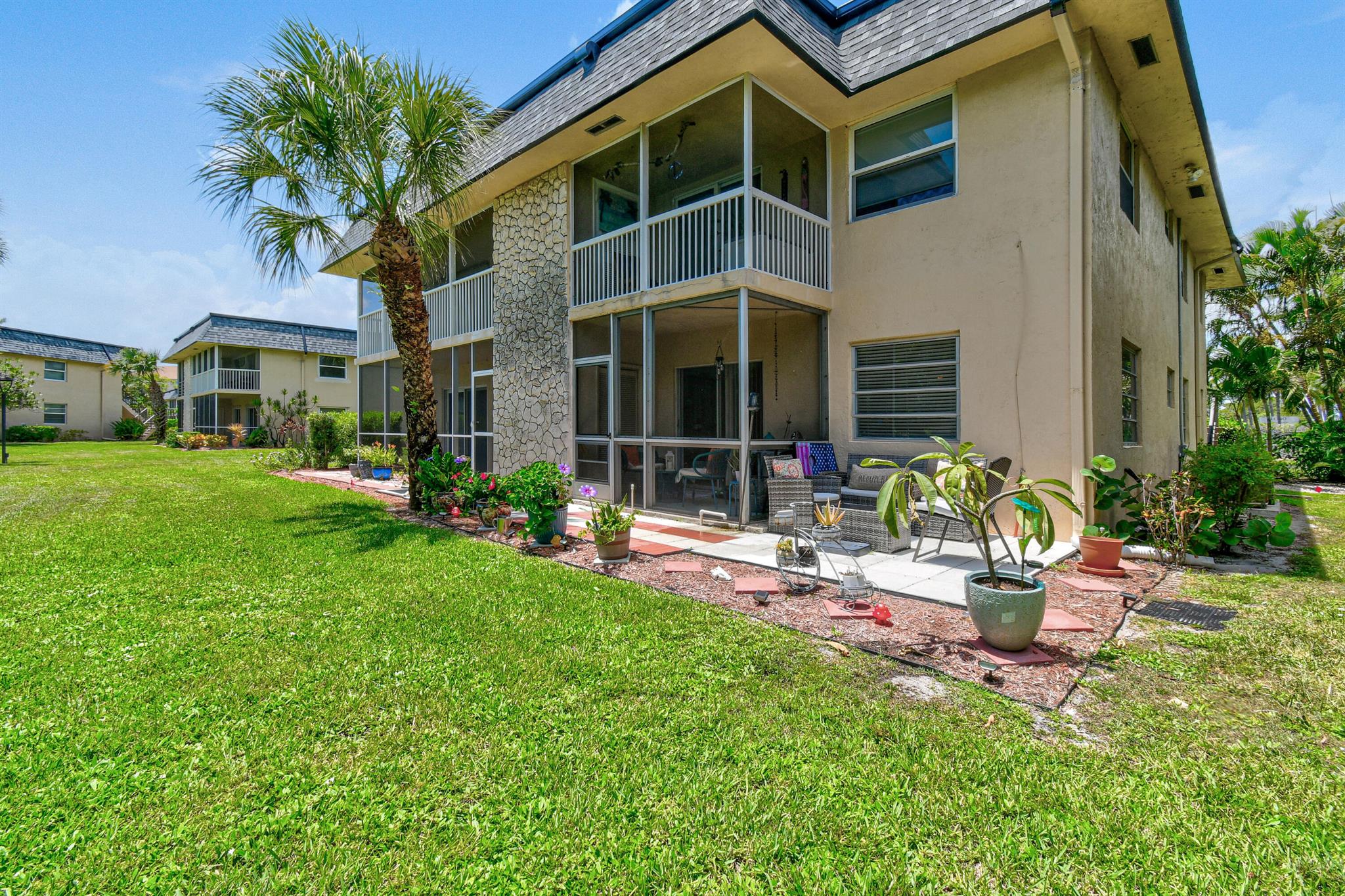 This is a fantastic 55+ community featuring two-story buildings, ideally situated just around the corner from Jupiter's beautiful beach. This first-floor end unit is incredibly light & bright. The main living area is fully tiled & the bedrooms feature laminate wood flooriing. The screened-in porch provides a peaceful setting with garden views & ocean breezes. The community offers amenities including a heated pool, clubhouse with an outdoor grill & common laundry facilities in each building. This community truly embodies the charm of ''Old Florida,'' being incredibly close to Jupiter's beautiful A1A & just steps away from the beachfront, the Maltz Theater & both Carlin & Dubois Parks. You'll find dining, shopping, golf, and the beach all within walking distance. Amazing opportunity!!