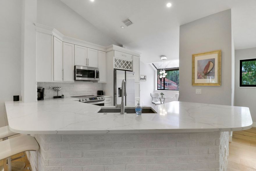 Enjoy paradise in this beautiful contemporary 2bedroom/2bathroom condo with one car garage at highly desirable community in Juno Beach. This spectacular vacation home has been completely remodeled with beautiful upgrades and all the modern luxury comforts. Hardwood floors and ceramic tile throughout. Large living area with vaulted ceiling leads to the kitchen and breakfast nook. In addition a separate dining area. The gourmet kitchen features stainless steel appliances and quartz counter tops. Motorized custom blinds in Master and Guest Bedrooms. Hurricane Windows installed recently. Seasonal rent includes water, internet , cable, and also electricity up to $100.