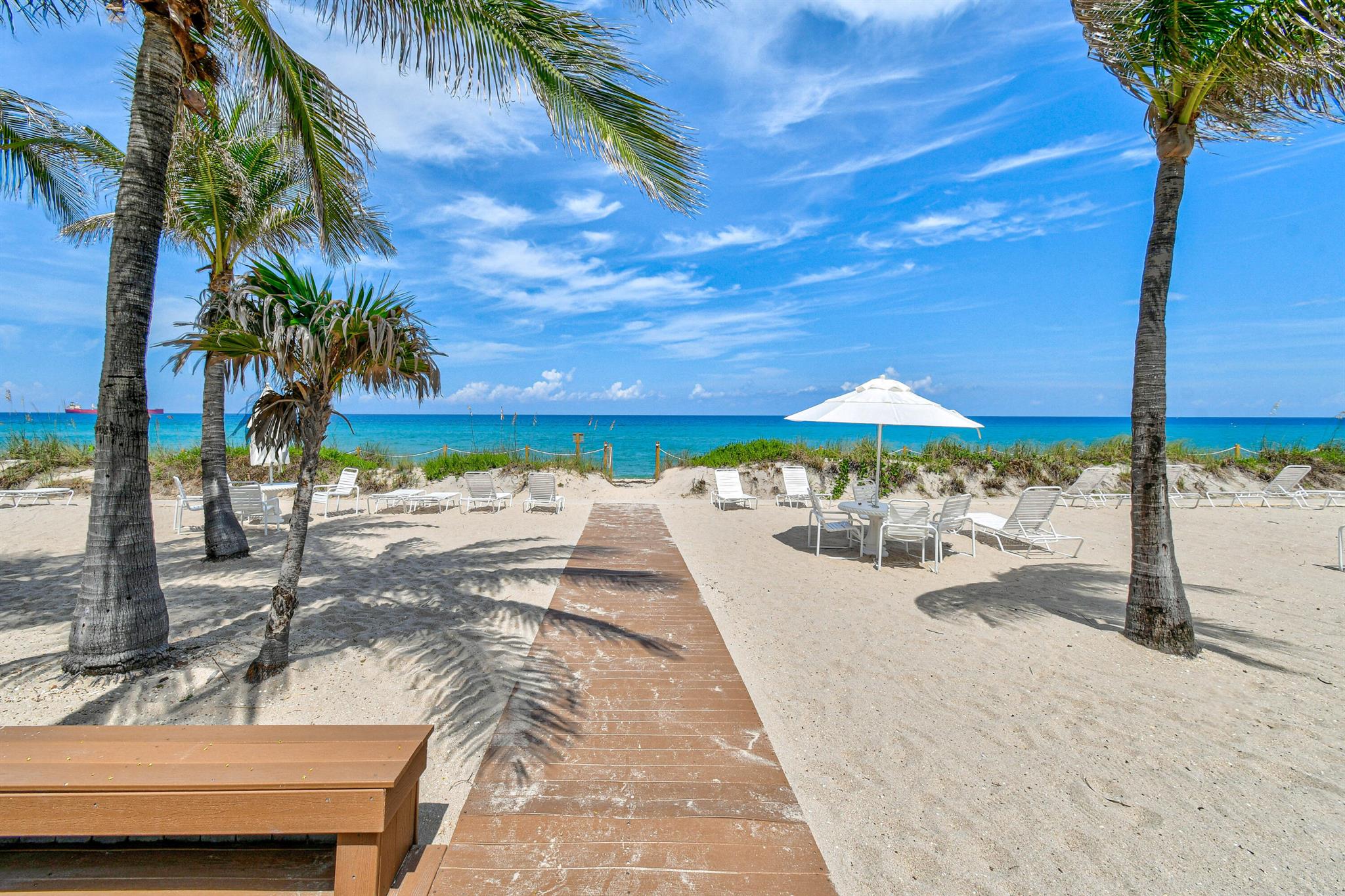 Ocean Towers North - Coastal Elegance, Timeless Nestled along approximately 300 feet of private beach, Ocean Towers North offers the ultimate Palm Beach lifestyle. Bask in the warm sea breezes and relax beneath swaying palm trees on the pristine sand and turquoise waters just steps from your door. This charming designed two-bedroom, two-bath residence features a spacious floor plan curated by legendary decorator Albert Hadley. The home includes a well-appointed kitchen with Maytag appliances, double-glazed windows, and the original terrazzo flooring throughout. The terrace provides a glimpse of the ocean as well as views of the iconic Warden House on North Ocean Boulevard.