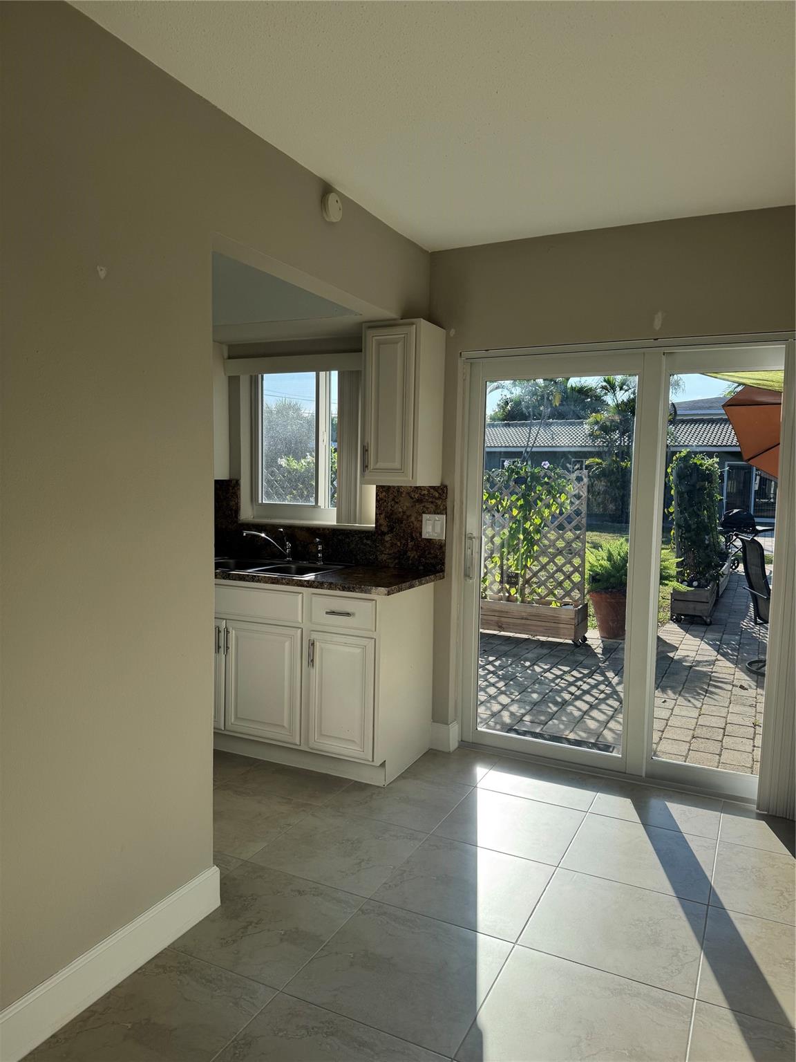 Come and see this amazing 1st floor unit, featuring a lot of natural light, tile floors throughout, Impact Windows and Doors, Updated bathroom, a large closet and more! Enjoy your very own patio area & extremely large shared backyard & mango tree. Shared laundry room on premises (located in the back of the building). Conveniently located 1 block east of Federal, near beaches, parks, shopping, restaurants and more! **Water/Trash is NOT included in rent payment, only landscaping. 1 parking spot, fits 2 cars Tandem (cars can not be on the sidewalk)