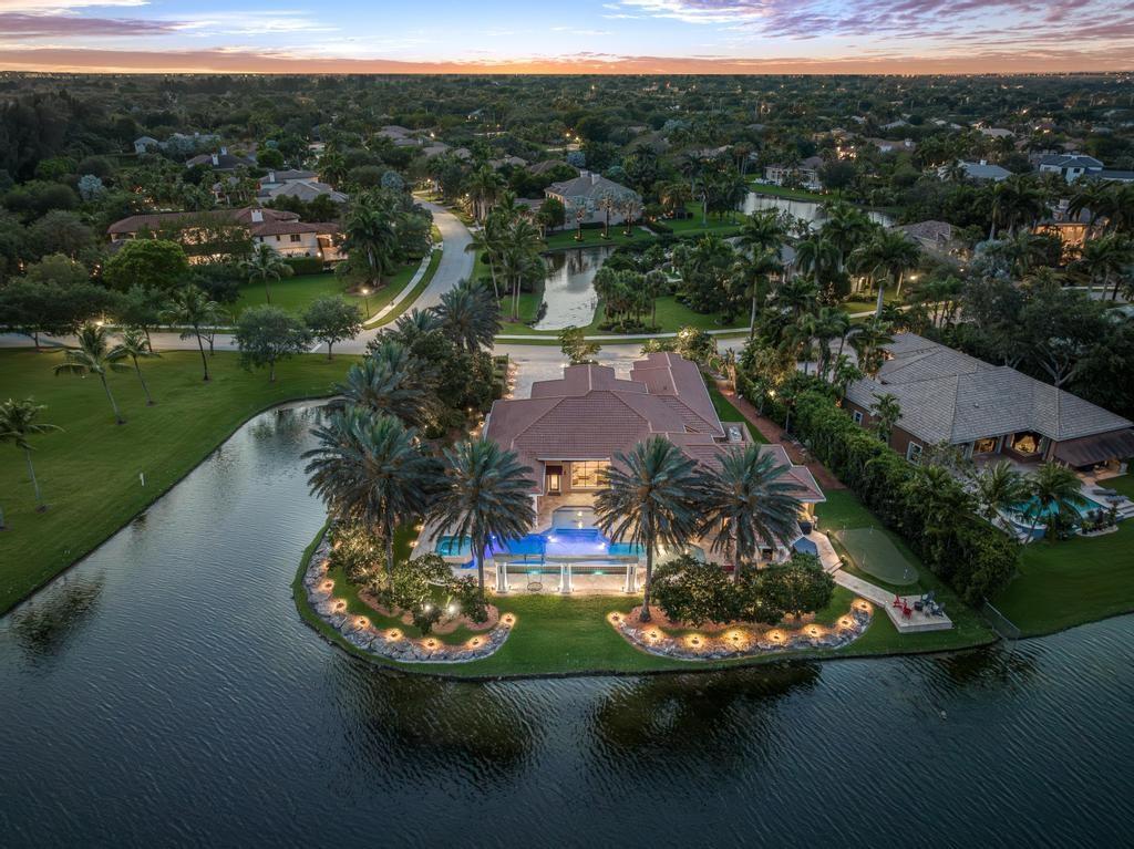 The Jewel of Stonebrook Estates! Spectacular waterfront point-lot with endless water view. This incomparable 6114 total sf, 1-story grand estate, features 6 generous bedrooms + office+ den, 5.5 bathrooms, 3-car garage, volume ceilings, 1room can be private guest suite, grand entry fountain, SS kitchen appliances & quartzite countertop. An entertainer’s outdoor lifestyle that leaves nothing left to be desired and is perfectly positioned for sun and shade! Custom infinity-edge pool, sun shelf, hot tub, in-pool dining tables, gazebo with summer kitchen, beer kegerator, Sonos speakers & a putting green overlooking the water views. 75KW full-house diesel generator, surveillance system & water softener/filtration system. Close to the renovated Clubhouse with playground, basketball, tennis & gym.