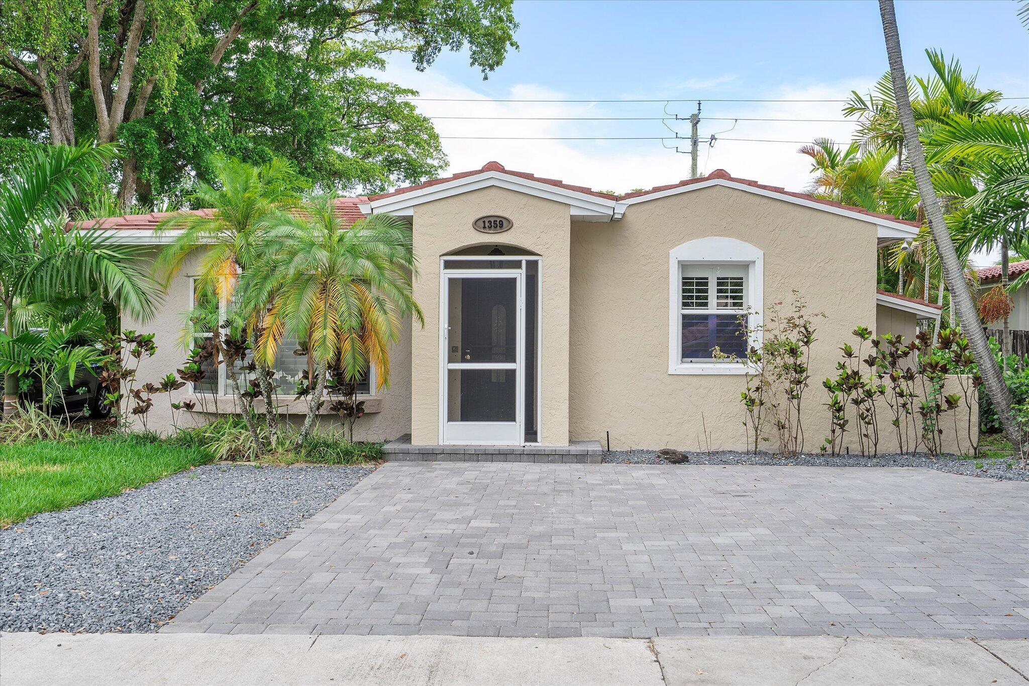 Spectacular corner lot full of charm and thoughtful upgrades! Just a short walk to downtown Hollywood and the Intracoastal, this beautifully updated home offers great curb appeal, a spacious layout, and flexible living space. Features include luxury vinyl plank flooring, fresh interior paint, and a chef's kitchen with Wolf gas stove, Sub-Zero fridge, large island, and generous storage. Both bathrooms have been fully renovated with high-end finishes -- including glass-enclosed shower, floor-to-ceiling tile, dual vanities, and a stunning freestanding tub in the primary suite. French doors lead to a screened porch. The converted garage serves as a third bedroom, office, or den. The fenced backyard features new turf, a custom playground, and paver driveway. Be sure to view the 3D tour attached