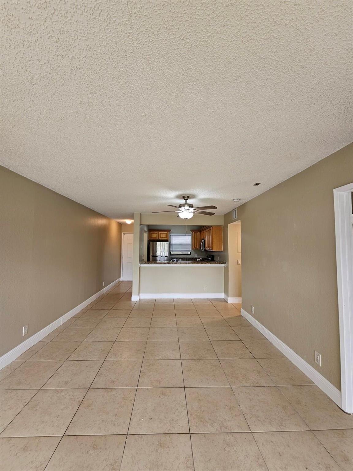 Beautiful 2-bedroom, 2-bathroom first floor unit with stunning lake views! This clean and well-maintained home features neutral colors, a kitchen with stainless steel appliances, granite countertops, and wood cabinetry. Washer and dryer in unit. Enjoy tile flooring throughout the main living areas and brand new laminate wood in the bedrooms. The unit includes a private screened porch and has been freshly painted move-in ready! Conveniently located just minutes from the Florida Turnpike and close to major roads including Okeechobee Blvd