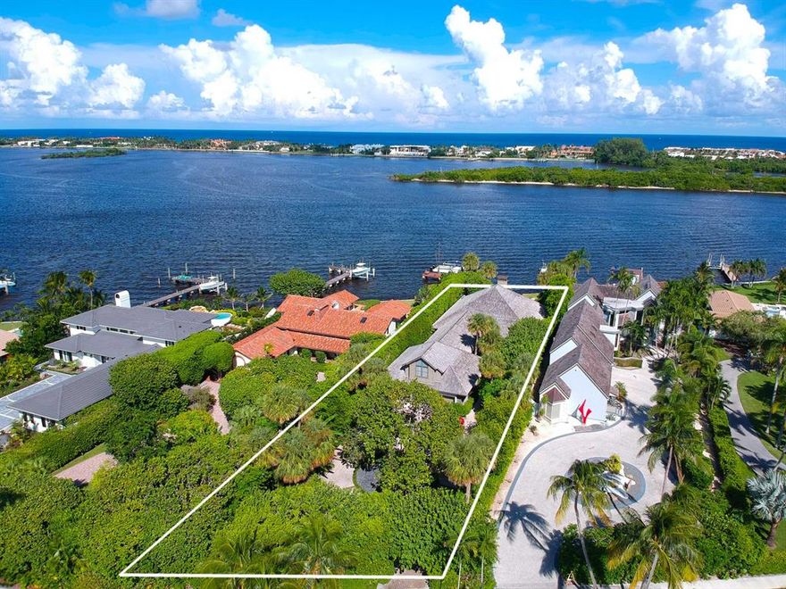 Direct intracoastal South Florida Tropical home with contemporary flare in the exclusive South End neighborhood. There are only 20 properties on direct open intracoastal in the South End. These are premier properties that are NOT in the flight path. Enjoy ocean breezes and intracoastal views from the private back porch of this custom designed home. The family room has 18ft vaulted ceilings overlooking the back porch, pool and expansive views of the intracoastal and Palm Beach. The remainder of the home has 91/2 ft ceilings. Master and two bedrooms are on the first floor and additional room above the garage. All rooms complete with en-suite baths and walk in closets.