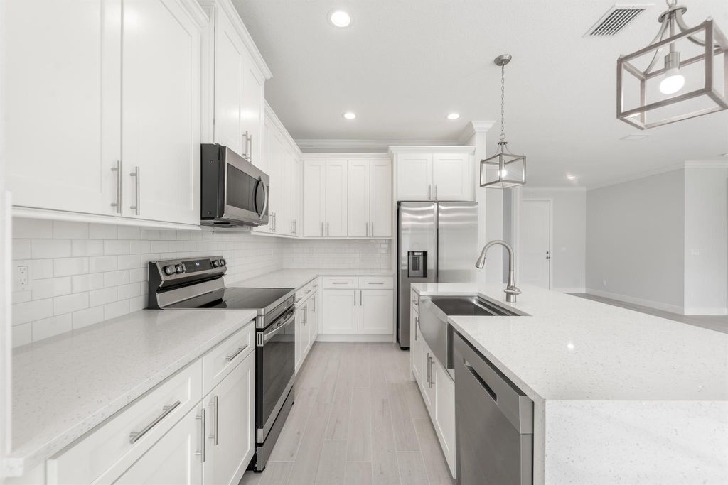 Photo of 2433 SW Hinchman Street, Port Saint Lucie, FL 34984 (MLS # R11103852)