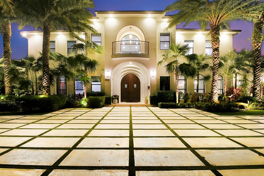 This Magnifcent furnished Estate is poised on nearly 1 Acre of the most unique and beautifully landscaped lots, complete with unique plants and rare trees, winding walking paths and even a putting green. The home features soaring ceilings, a butterfly staircase, a gourmet chef's kitchen w/ custom cabinetry, quartz and marble counters, Wolf oven, Sub-Zero refrigerator and a 7 burner Lacanche Gas Stove w/ oven.  The living room has a 2 story floor to ceiling window and firecplace. The first floor also features a Media/ Game room, a bedroom & bedroom/office . Upstairs there is a gorgeous oversized Master and stunning bath, a loft and 3 additional bedrooms. Impact glass, full house generator,  salt water pool, summer kitchen & gated motorcourt. *Please see supplement for Seller's Upgrades* Seller Improvements
7 Solar Panel System
Whole Property fencing
Smaller area Dog Pen fencing
Second Laundry room downstairs
RV out door plug and Tesla Plug
Indoor Garage golf cart plug
2021 Icon Six seater gof cart with Large tires, stereo and only 125 miles
Automated blinds in 7 areas
1 lemon and 1 mango tree
Upgraded Doorbell system
New Camera System
Digital door locks to 3 closets and office
 40 Clusia for Northern property line and 10 for Eastern property line for privacy