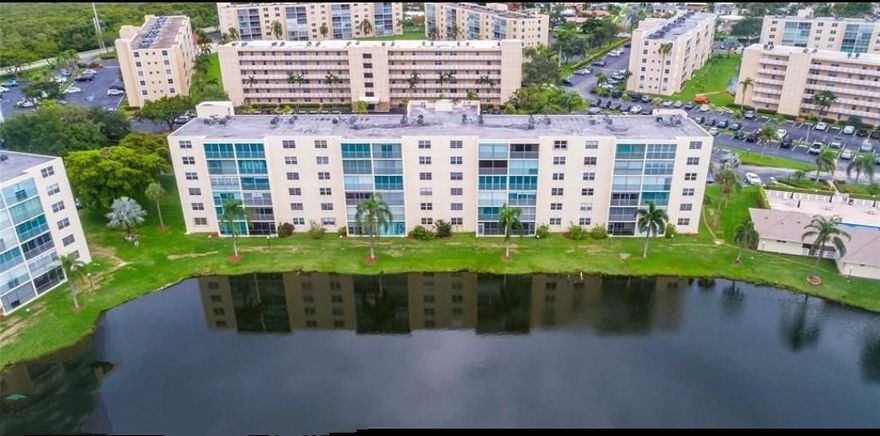 Wake up to stunning lake views in this oversized 1,100+ sq ft 2BR/2BA corner unit at Meadowbrook Lakes, a sought-after 55+ Dania Beach community. Corner layout offers rare windows in both bedrooms for abundant natural light. New hurricane-impact windows (Mar 2024) & roll-down balcony shutters for added protection. Relax on the screened balcony overlooking serene water, steps from the pool, clubhouse, elevator, laundry & storage. Enjoy a well-maintained neighborhood with resort-style amenities including pools, shuffleboard & social rooms. Prime location minutes to Hollywood Beach, Dania Pointe, dining, shopping & FLL Airport.. Building passed 40-year recertification in 2021. Move-in ready with immediate rental potential—ideal for investors or a low-maintenance coastal lifestyle!