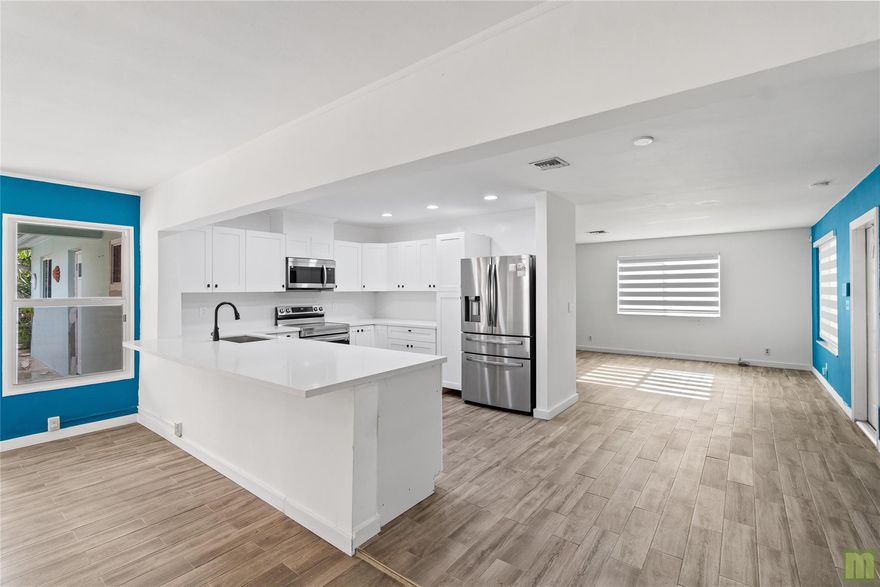 Beautifully renovated home in South Coconut Creek. 3 roomy bedrooms & 2 bathrooms with a private primary en-suite. The kitchen is the heart of any home and it shows with clean white shaker cabinetry, stainless steel appliances, quartz countertops & island seating. Stylish wood-look tile flooring, modern bathrooms featuring glass shower enclosures, & designer tiles. Modern motorized blinds adorn large windows that flood the space with natural light. There's also a brand new, OWNED solar system (50k value) included in the price, 2016 Roof, 2021 A/C, 2024 water heater, updated electrical & more! Enjoy Florida living in a beautiful in-ground pool, covered patio & roomy, fenced yard.  yes, you can have it all - and NO HOA!!! Close to schools, shopping, the turnpike & just 7 miles to the beach.